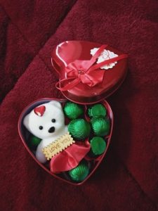Red heart shaped box with teddy